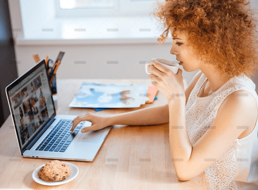 demo-attachment-493-woman-photographer-drinking-coffee-and-working-PJNBP6U